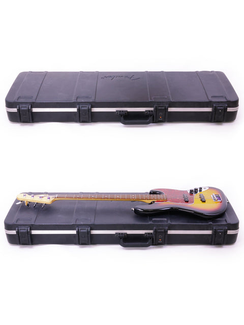 Two Fender Jazz Basses, Mexico 2013 model, neatly placed in a case on a white surface.