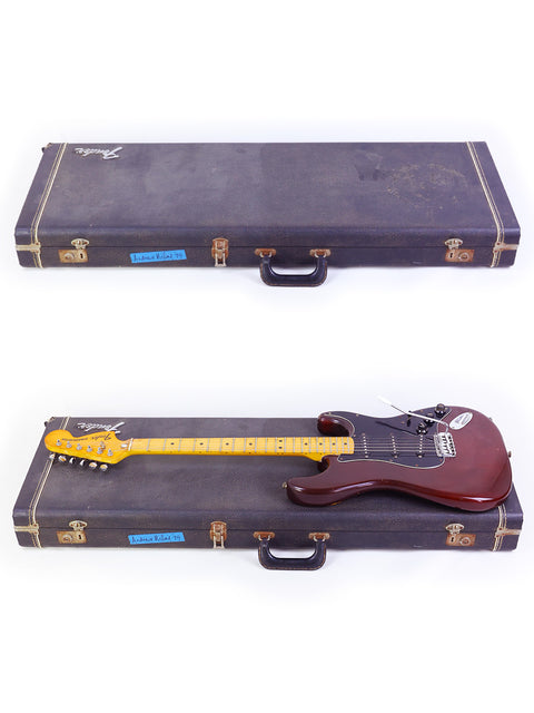 Two guitars, featuring a 1979 Fender Stratocaster, stored in a classic wooden case.