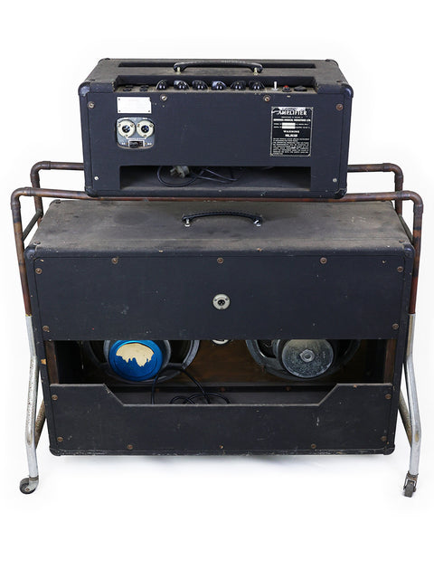 Two vintage VOX AC50 MKII amplifiers from 1968 placed atop a suitcase, highlighting retro music gear.
