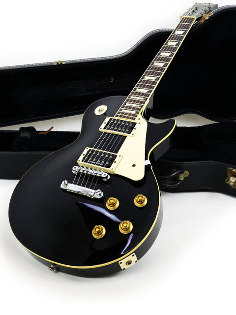 Vintage 1979 Tokai Les Paul Reborn LS50, a black electric guitar resting in its case, highlighting its timeless appeal.