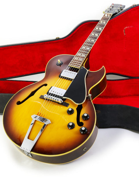 Vintage Gibson ES-175D guitar in a case, displayed on a clean white background, showcasing its classic design from the 1970s.
