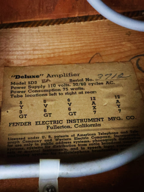 Vintage electrical box with a label, reflecting the classic style of the Fender Tweed Deluxe Amp 5D3, USA, 1955.