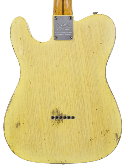 Yellow wooden guitar's back, highlighting the design of the Fender Master Built Carlos Lopez 70th Anniversary Broadcaster from 2020.